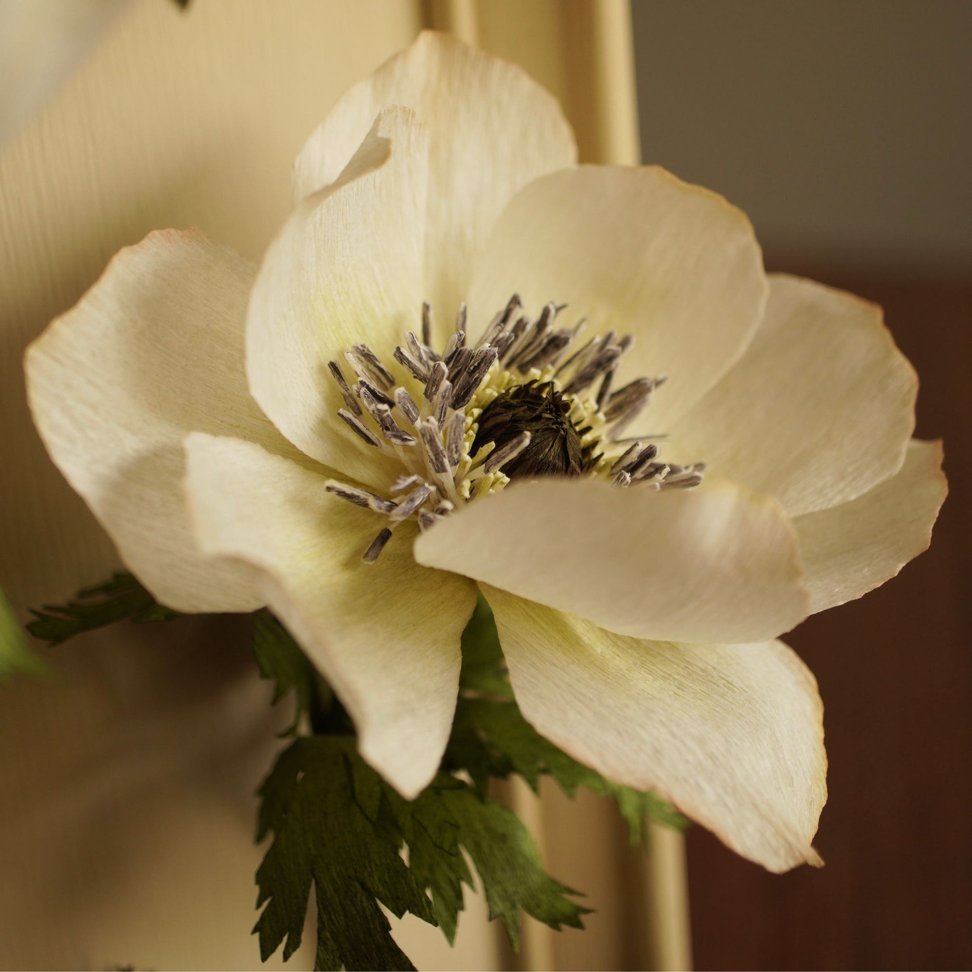 Close up detail of a paper nenome flower centre with handcrafted stamens