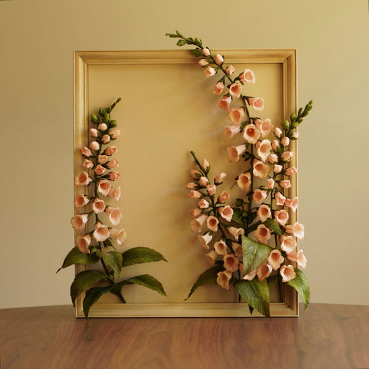 Framed paper foxglove botanical artwork with soft peach blooms and green leaves on a neutral background